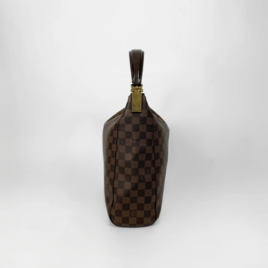 Brown checkered handbag with gold clasp on a white background