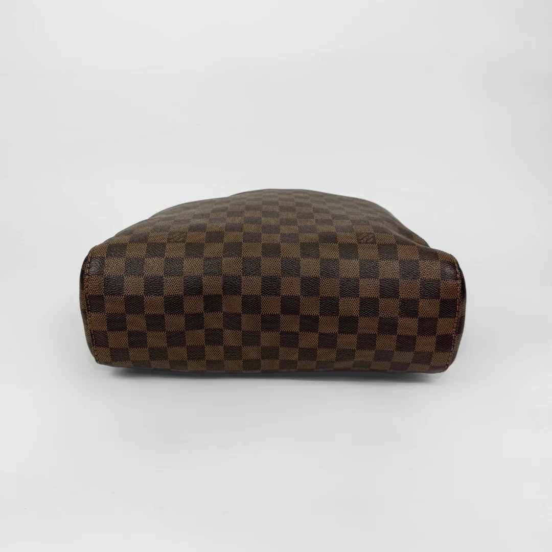 Brown checkered handbag with gold clasp on a white background