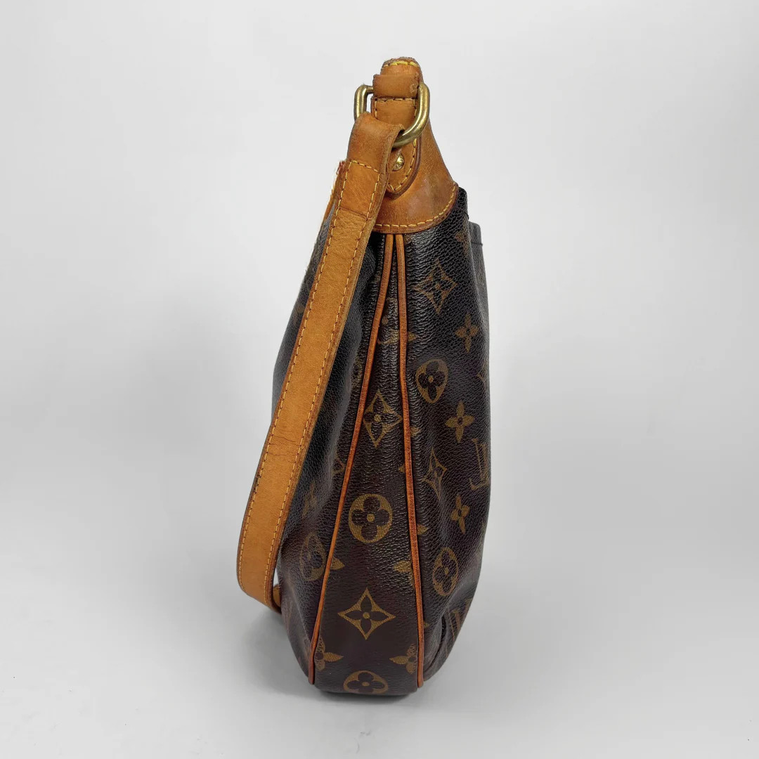 Brown leather handbag with visible brand logo on a white background