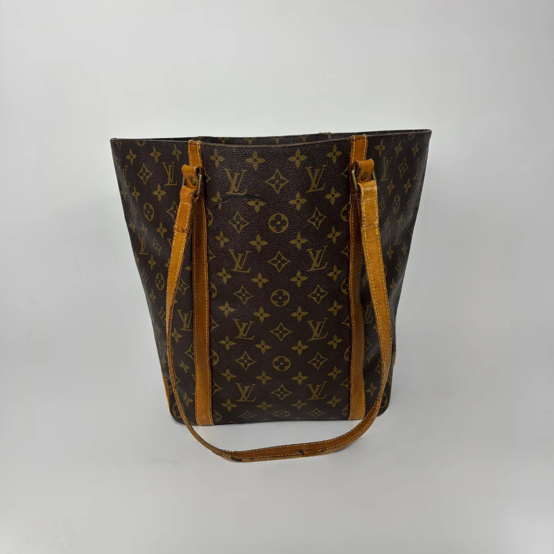 Designer handbag with monogram pattern on a white background