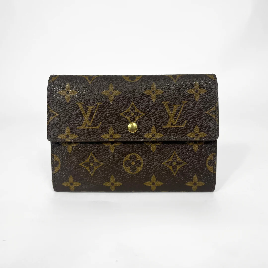 Louis Vuitton wallet with monogram pattern on a white background
