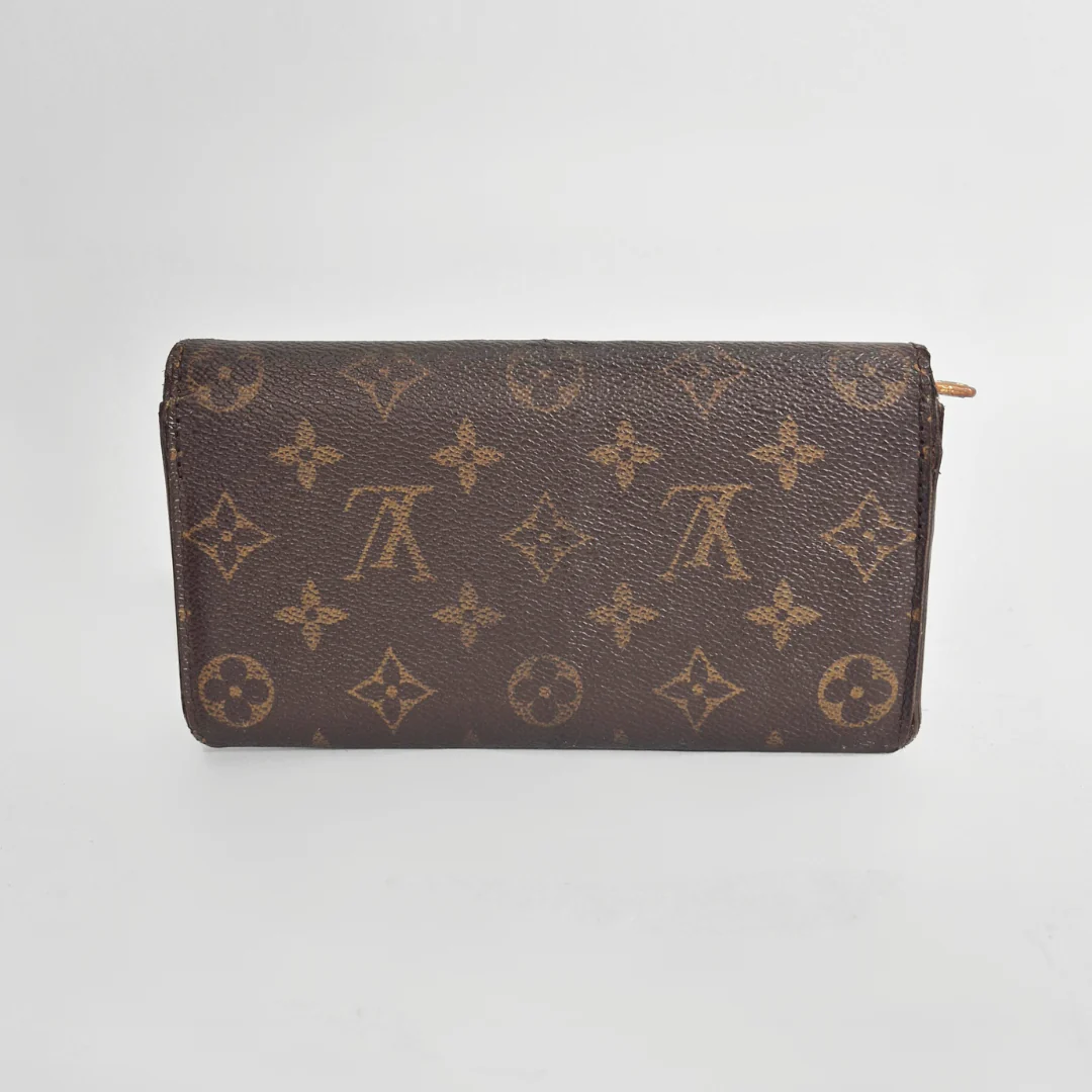 Brown wallet with monogram pattern on a white background