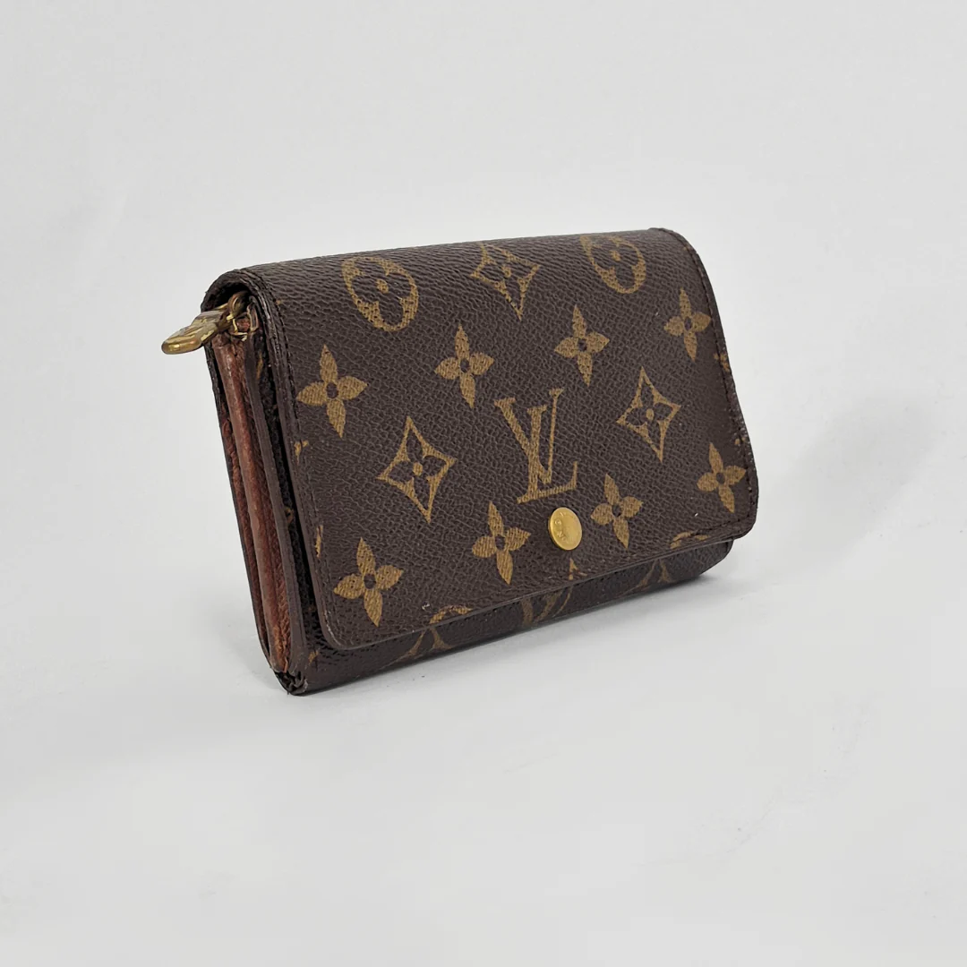 Louis Vuitton wallet with monogram pattern on a white background
