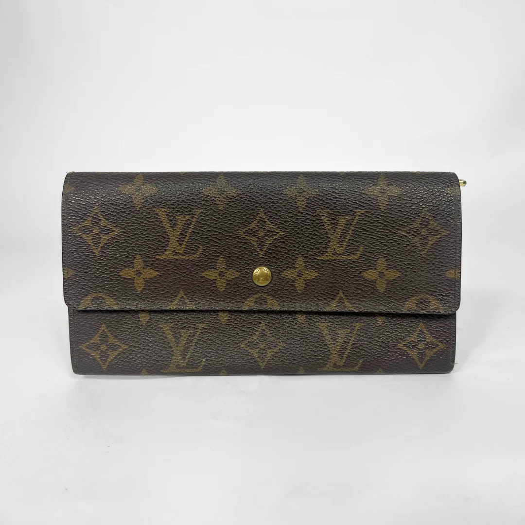 Louis Vuitton wallet with monogram pattern on a white background