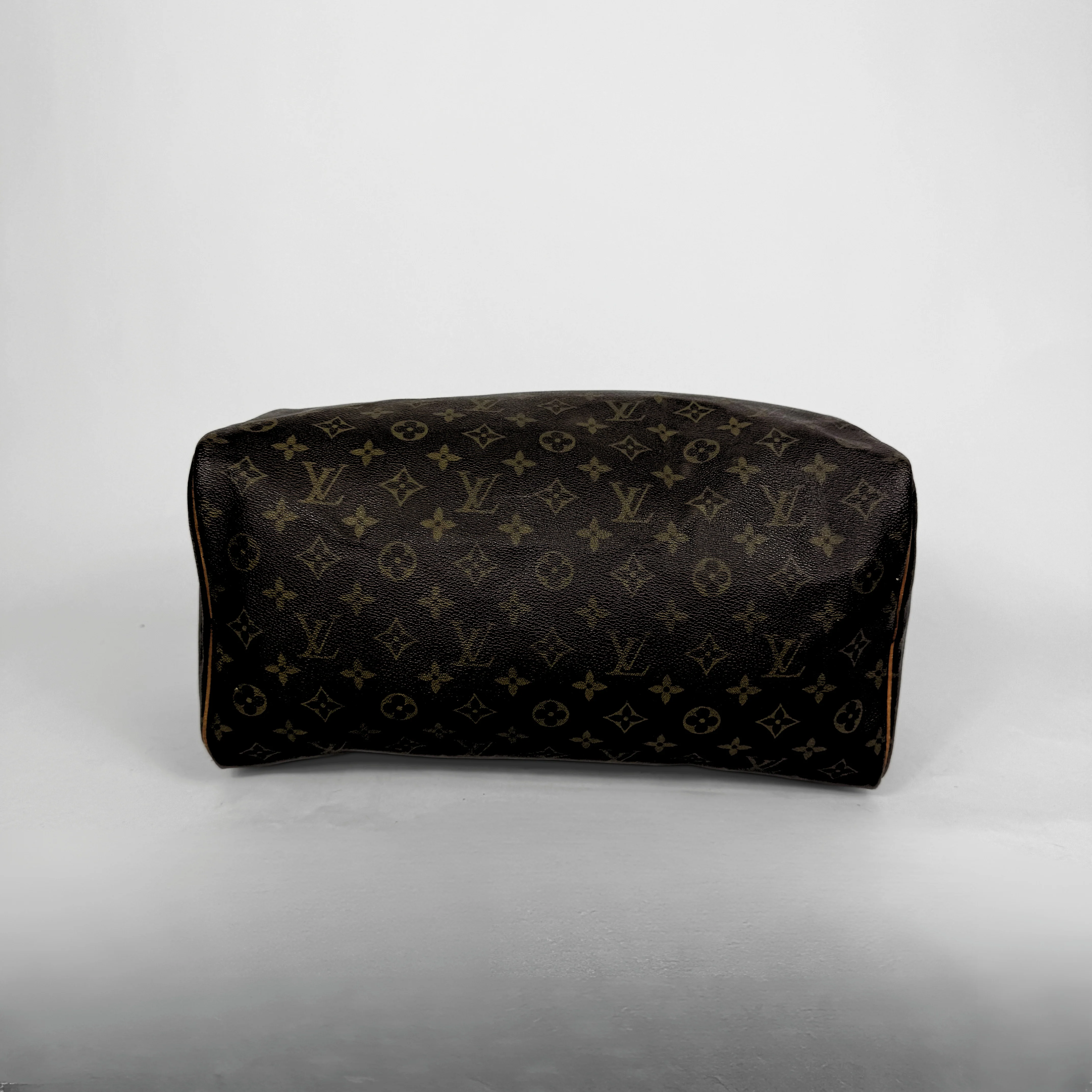 Designer handbag with monogram pattern on a light gray background