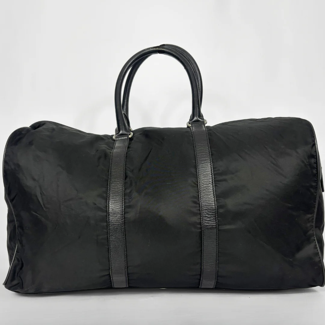 Black backpack with a strap and lock on a white background