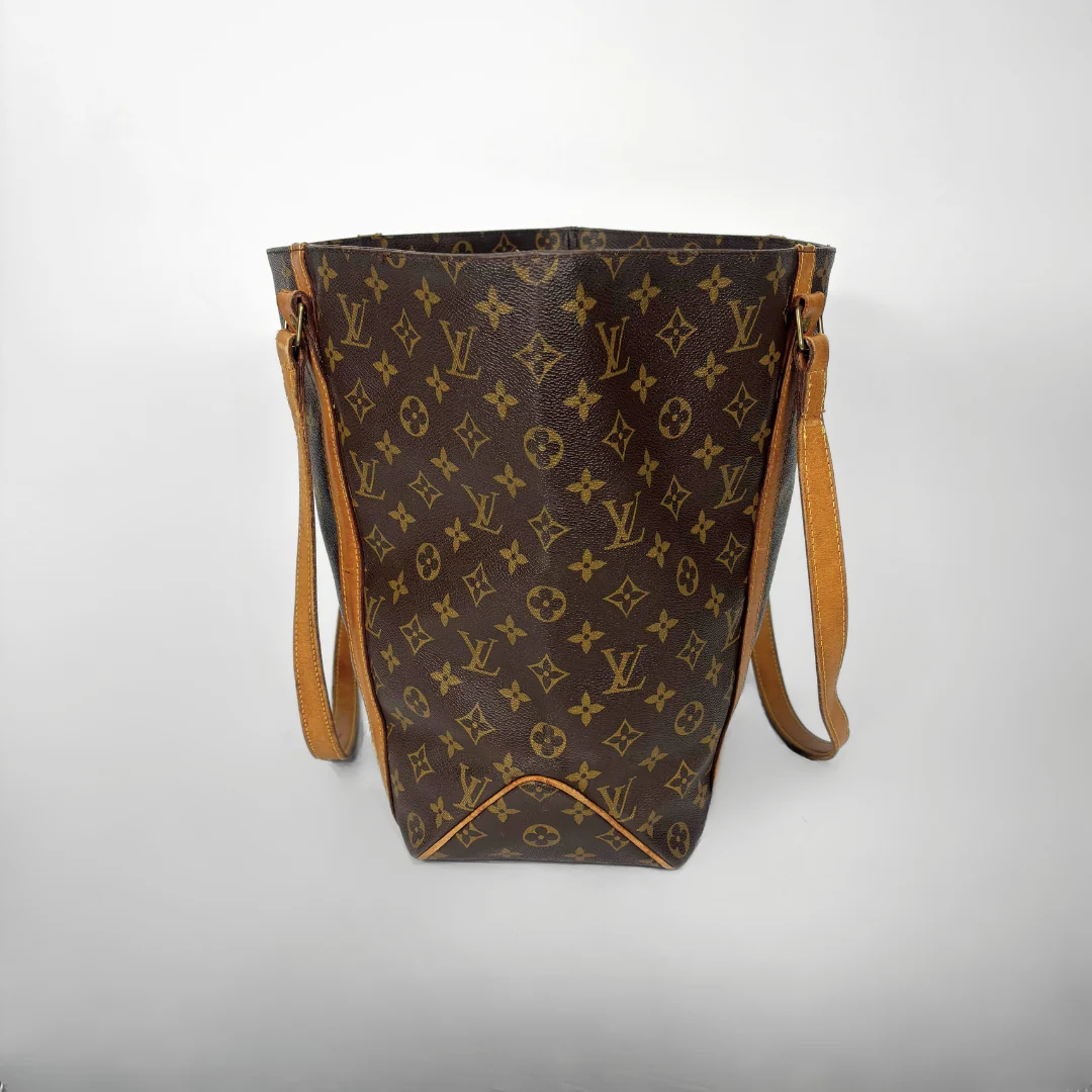 Brown handbag with monogram pattern on a white background