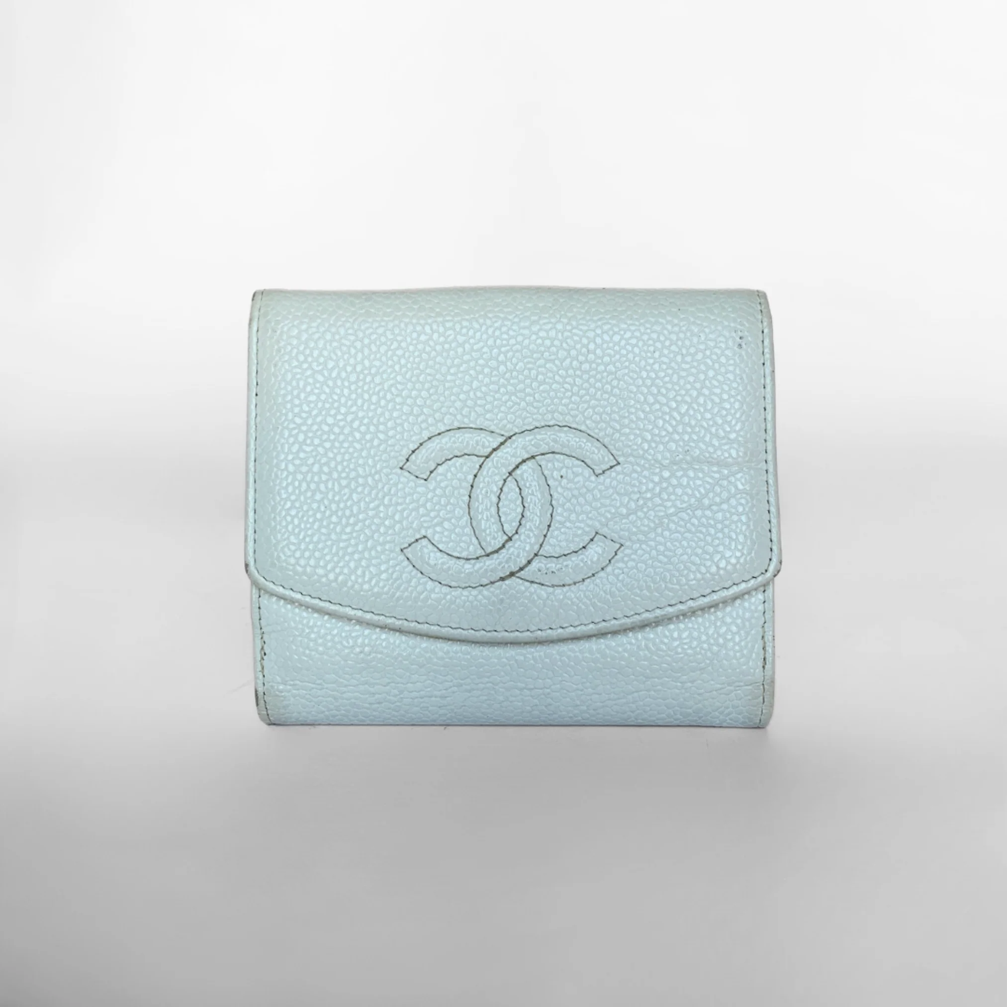 A small baby blue Chanel wallet made of caviar leather, featuring the brand's logo embossed on the front.
