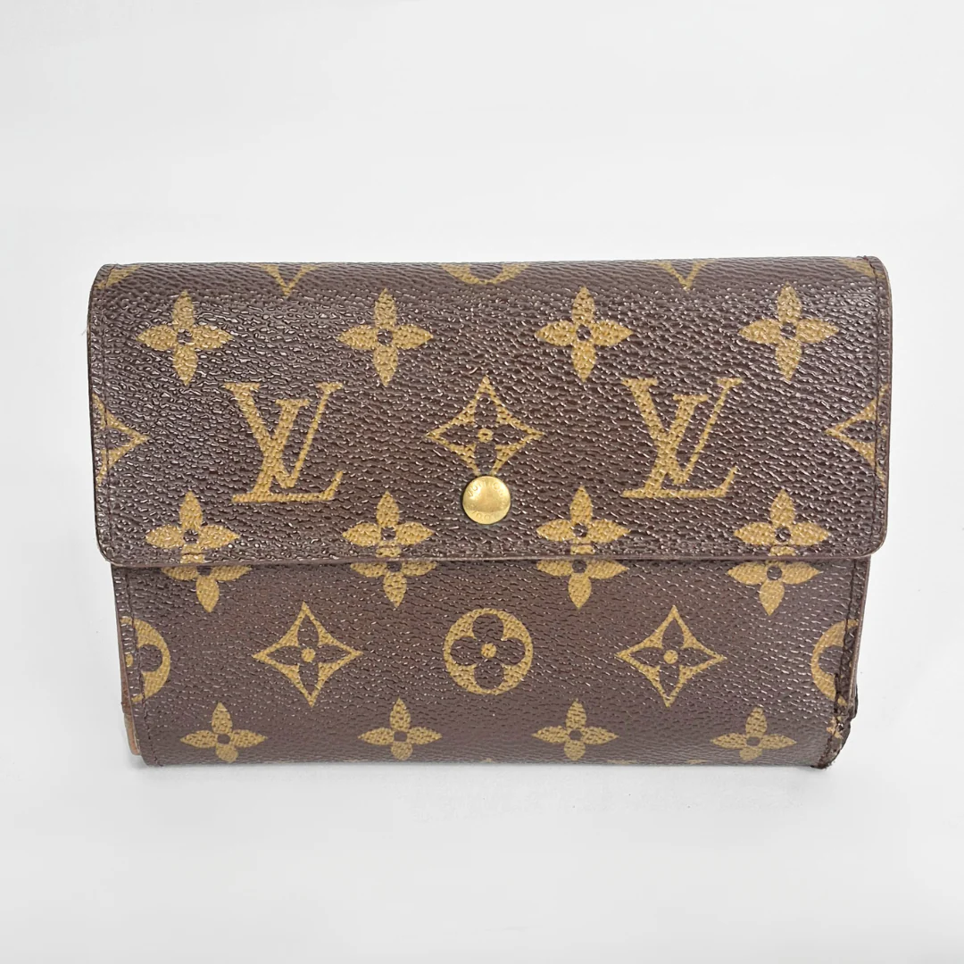 Louis Vuitton wallet with monogram pattern on a white background