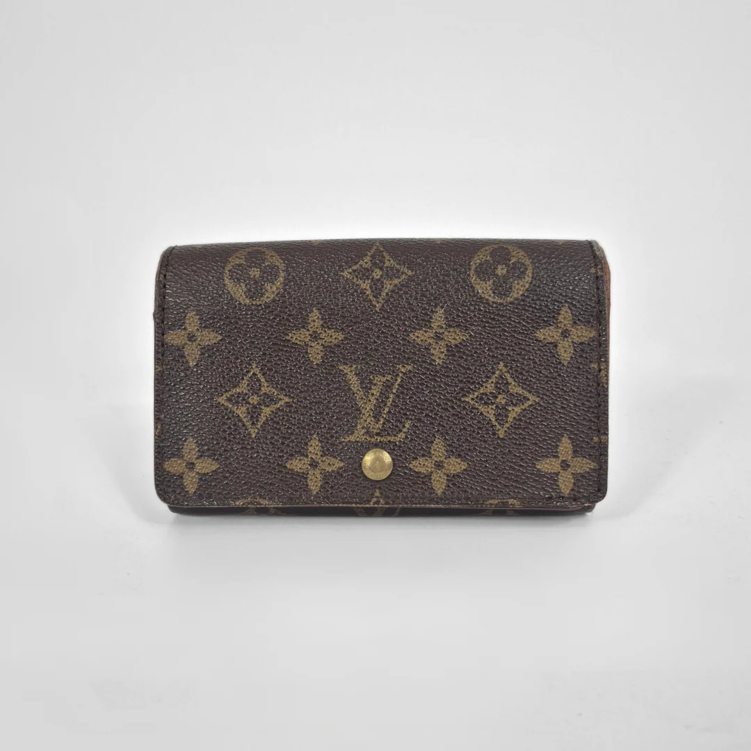 Louis Vuitton wallet with monogram pattern on a white background