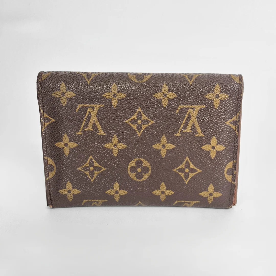 Louis Vuitton wallet with monogram pattern on a white background