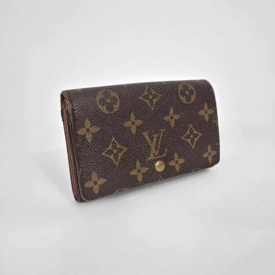 Louis Vuitton wallet with monogram pattern on a white background