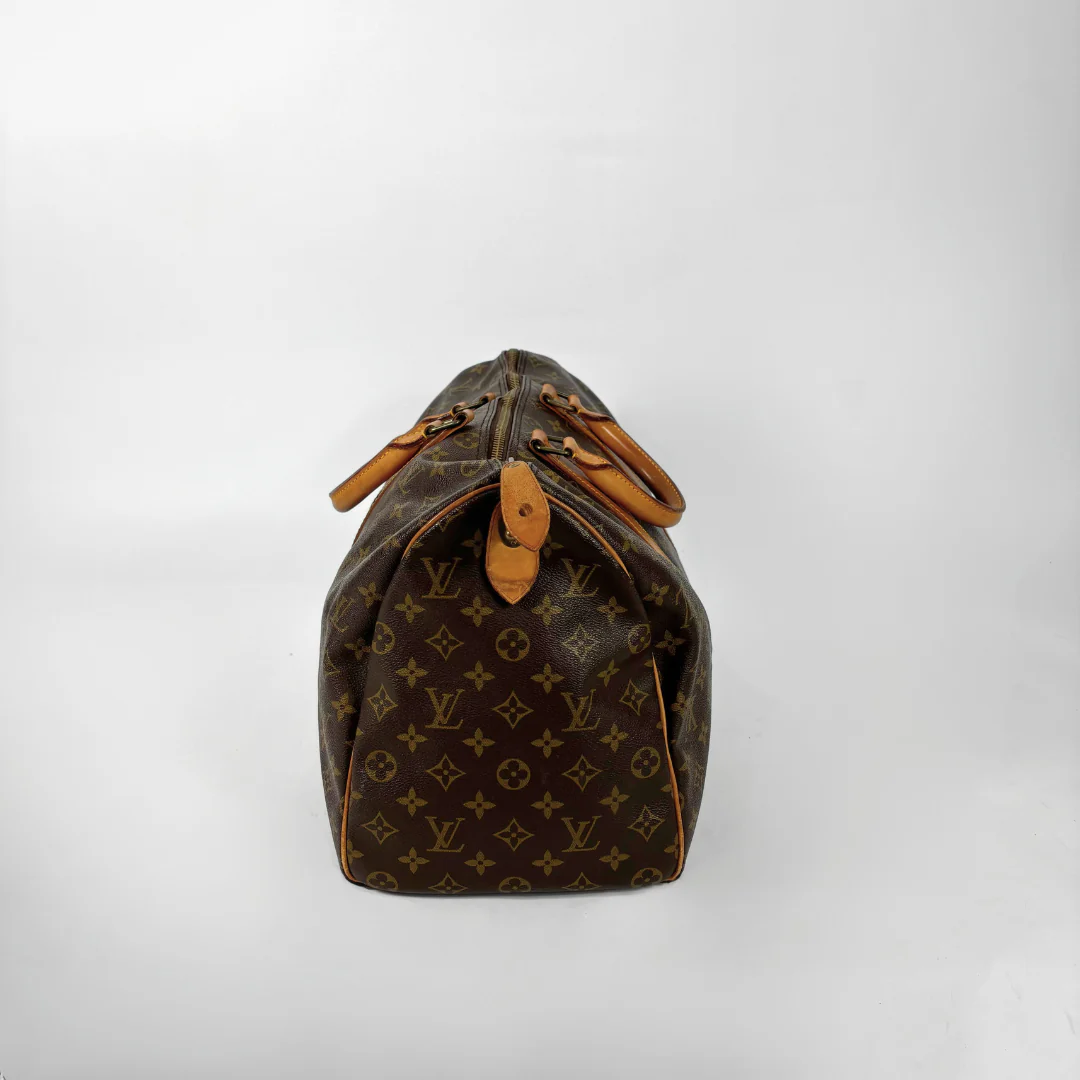 Brown Louis Vuitton handbag with monogram pattern on a white background
