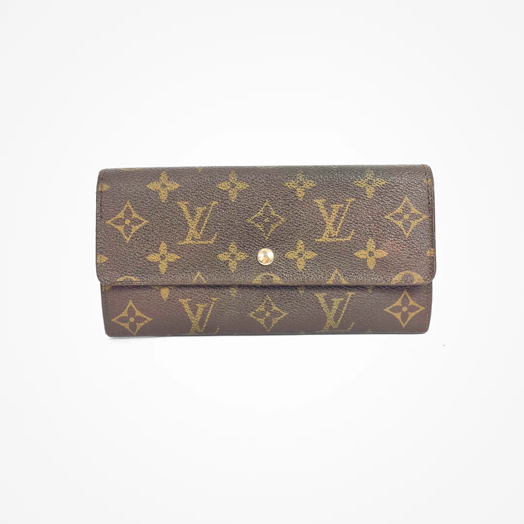 Brown LV wallet with gold monogram pattern on a white background