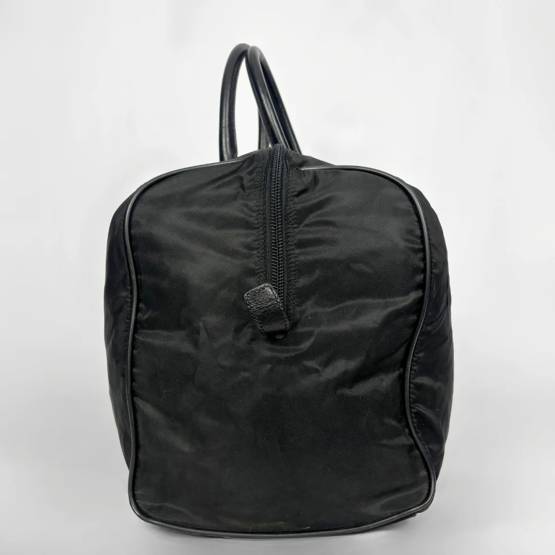 Black backpack with a strap and lock on a white background
