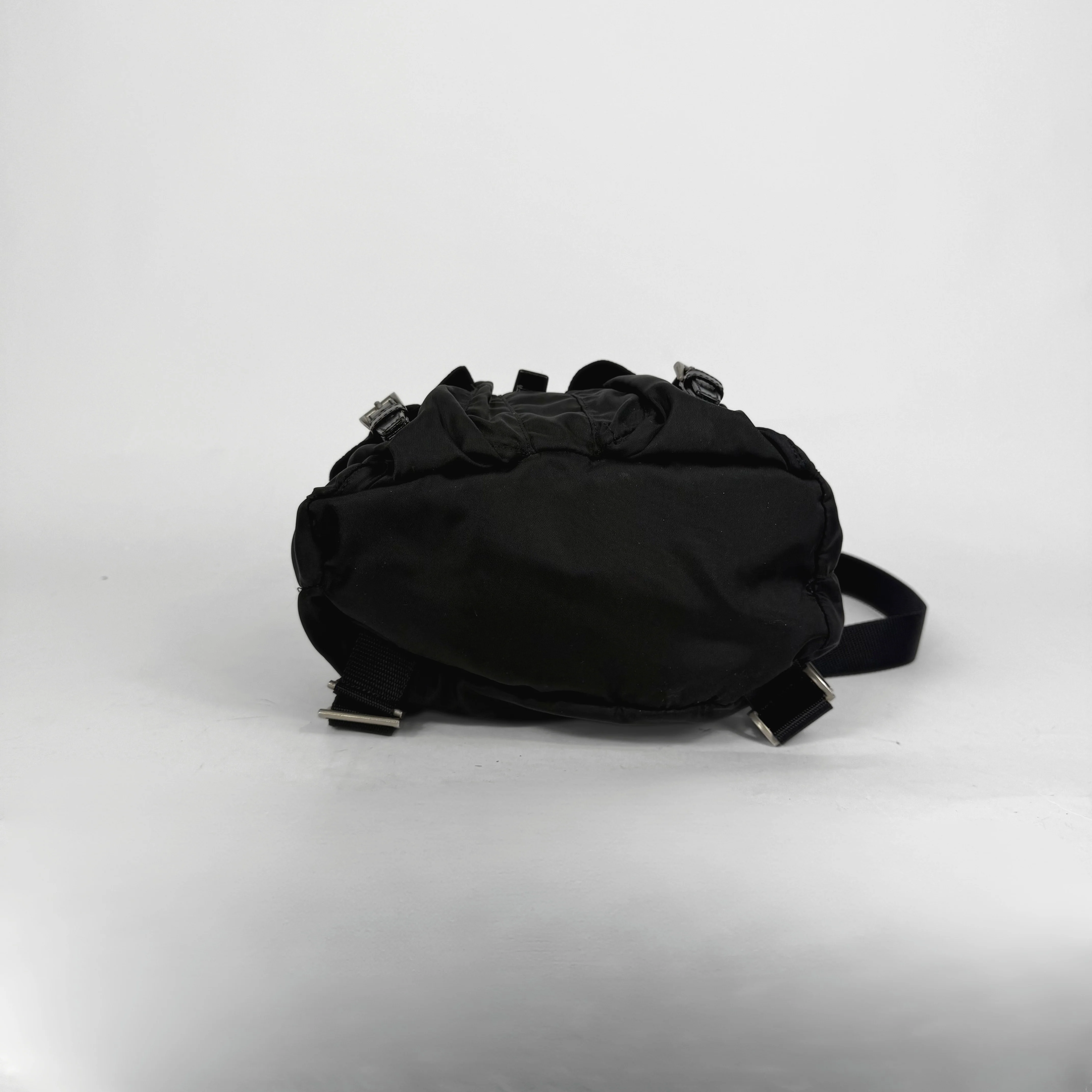 Black backpack on a light gray background
