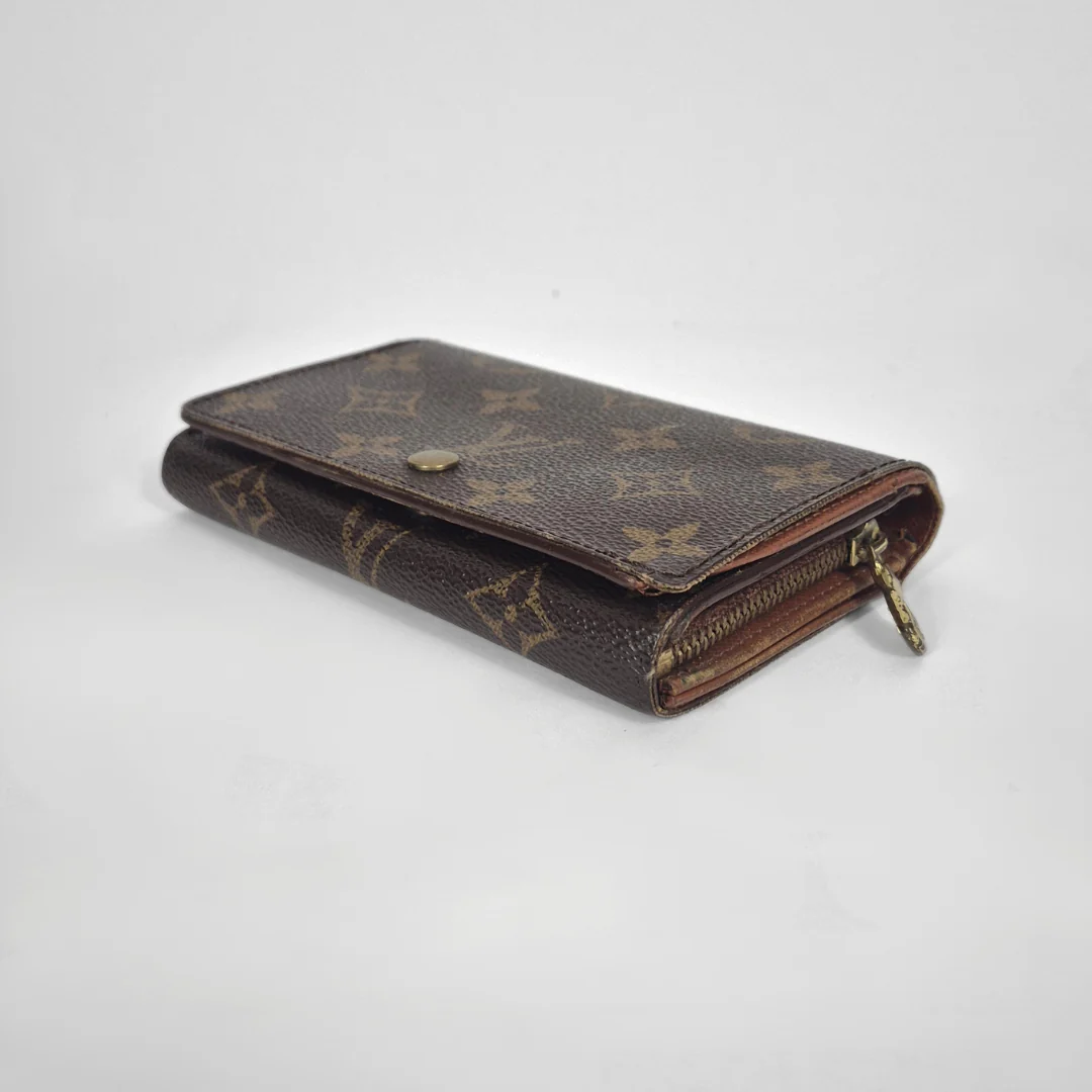 Louis Vuitton wallet with monogram pattern on a white background