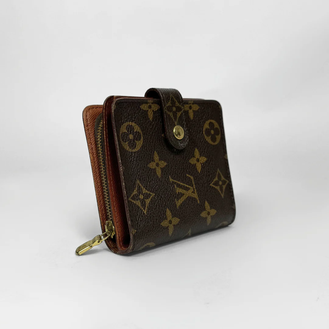 Brown wallet with gold monogram pattern on a white background