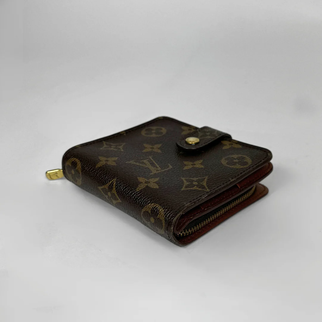 Brown wallet with monogram pattern on a light gray background