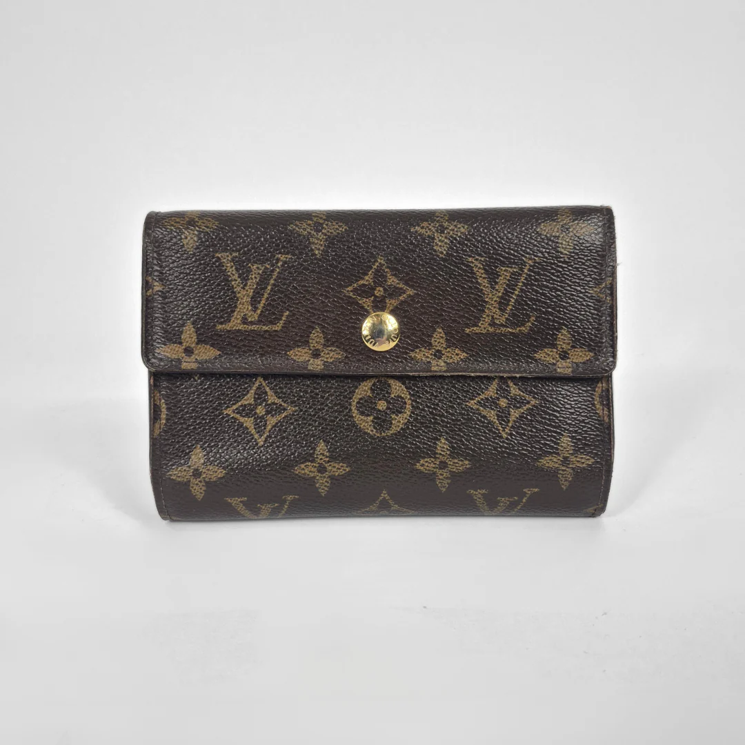 Louis Vuitton wallet with monogram pattern on a white background