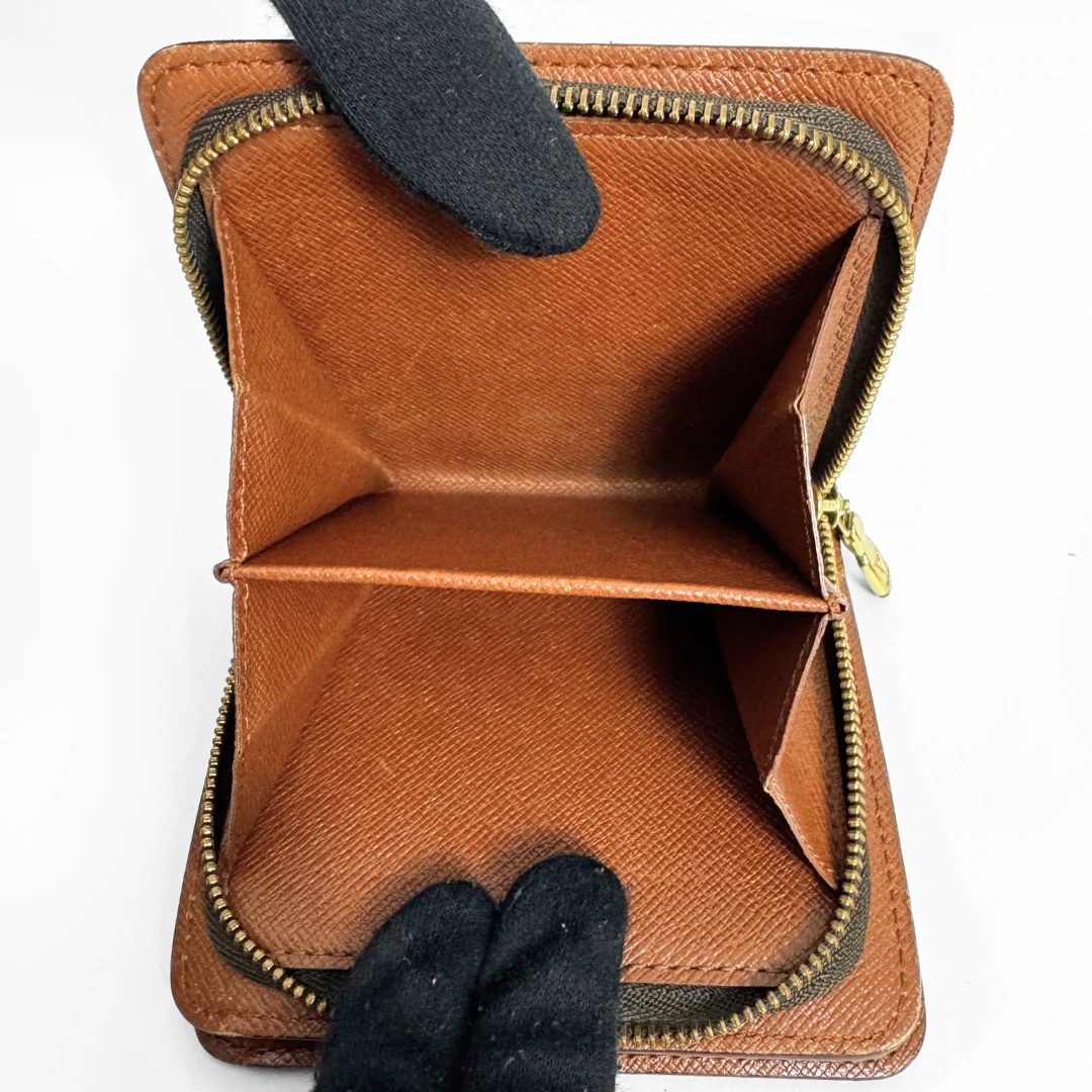 Brown leather wallet with gold zipper on a white background