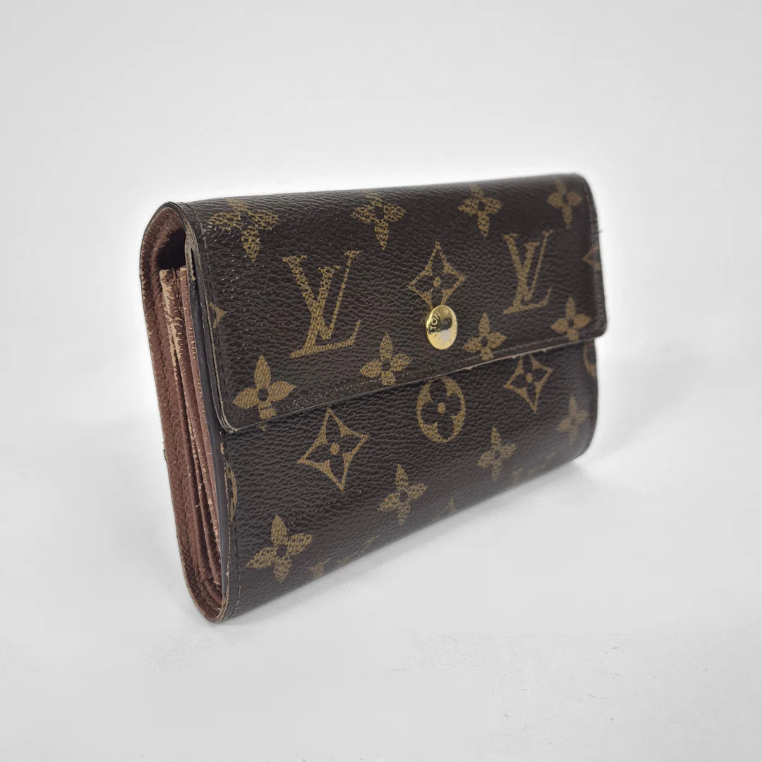 Louis Vuitton wallet with monogram pattern on a white background