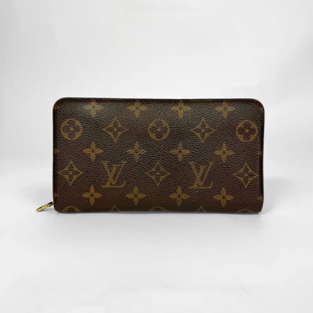 Louis Vuitton wallet with monogram pattern on a white background
