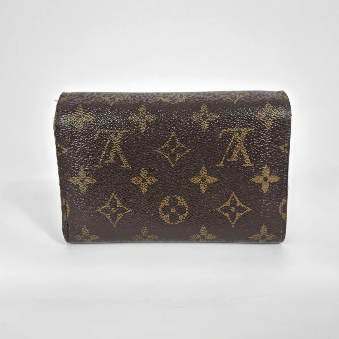 Brown leather wallet with gold monogram pattern on a white background