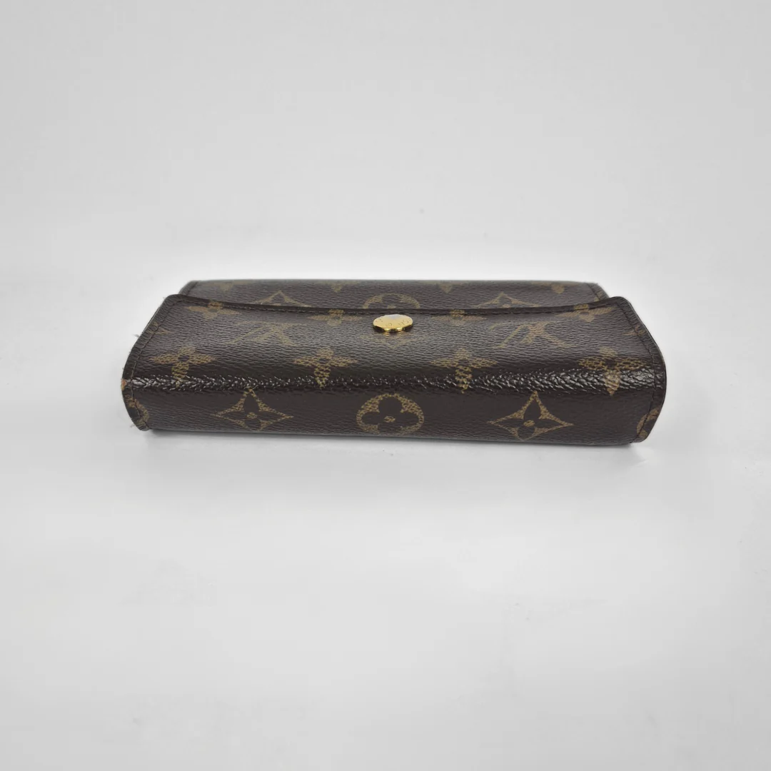 Louis Vuitton monogram clutch on a light gray background