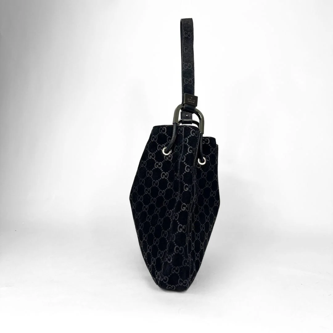 Gucci GG black suede shoulder bag on a white background