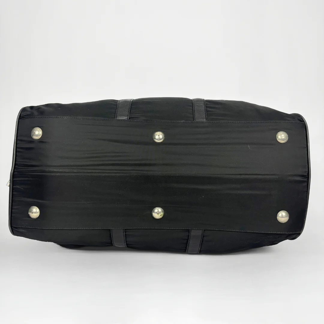 Black backpack with a strap and lock on a white background