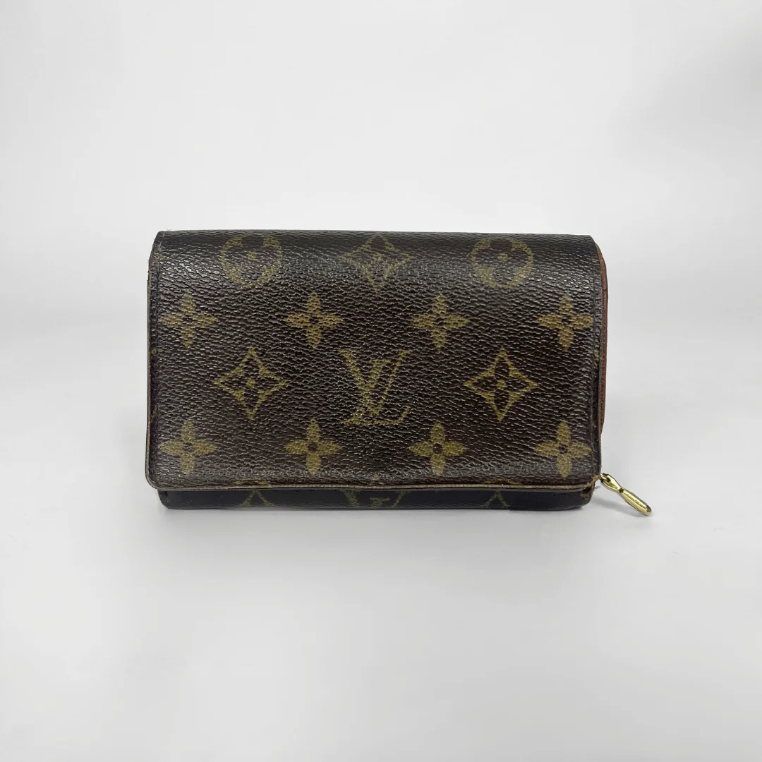 Louis Vuitton wallet with monogram pattern on a white background