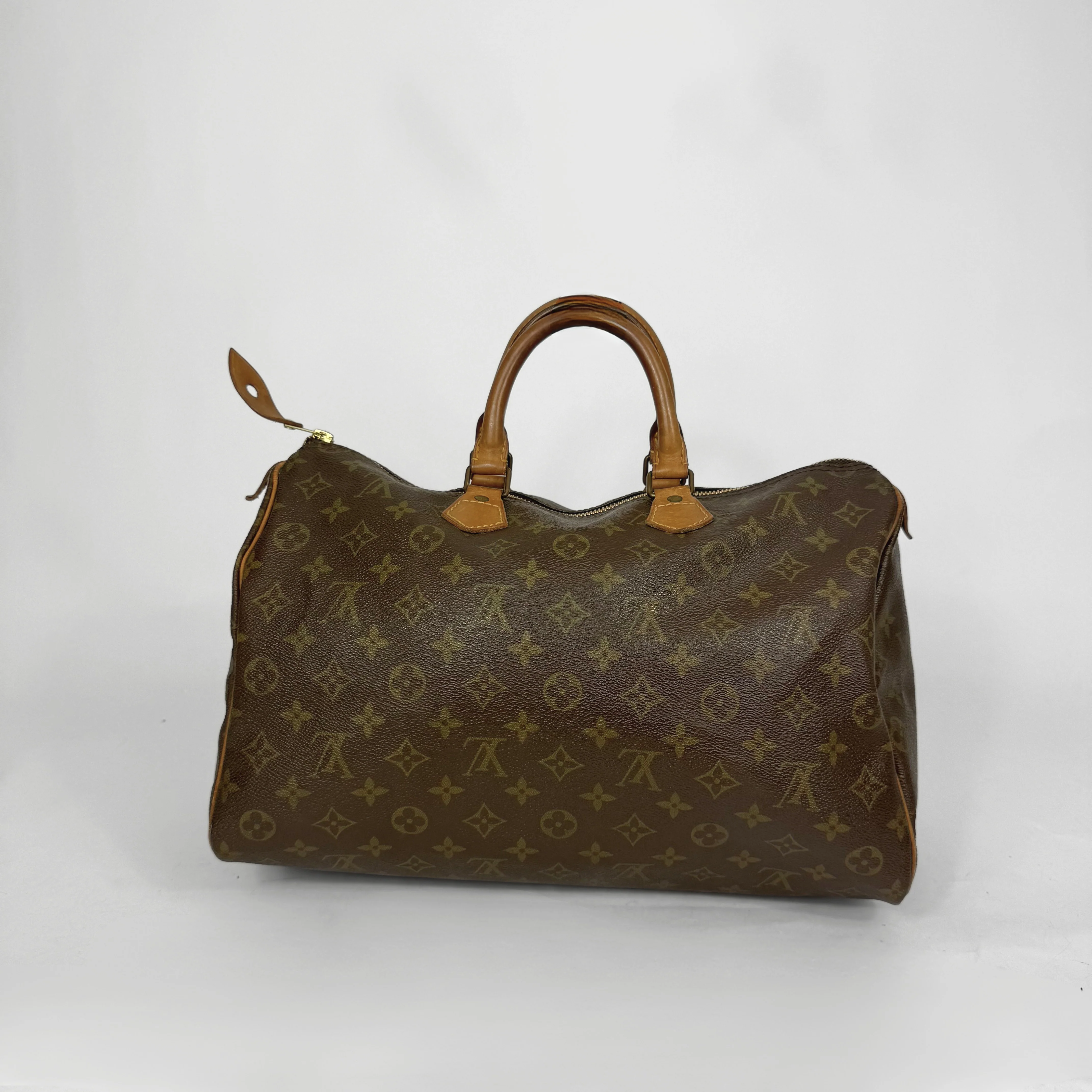Brown monogram handbag on a white background