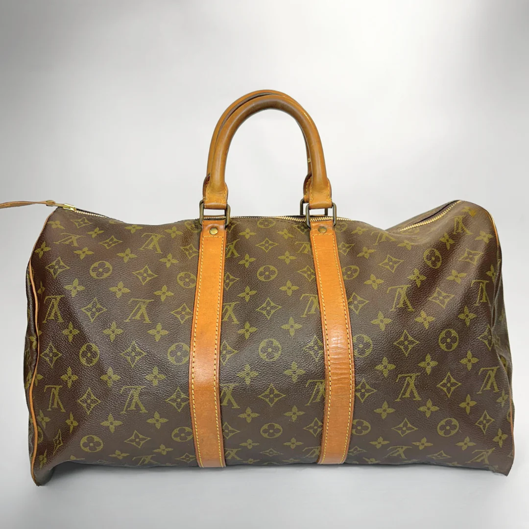 Brown travel bag with tan handles and straps on a white background