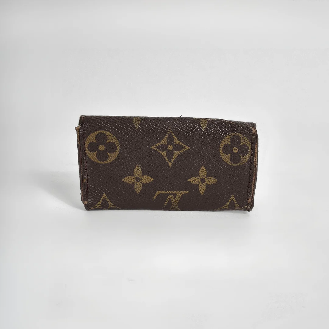 Louis Vuitton wallet with monogram pattern on white background