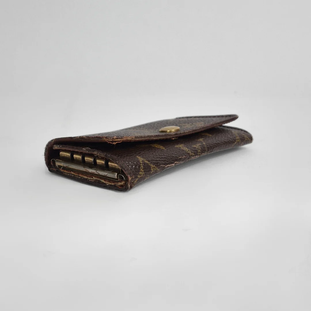 Louis Vuitton wallet with monogram pattern on white background