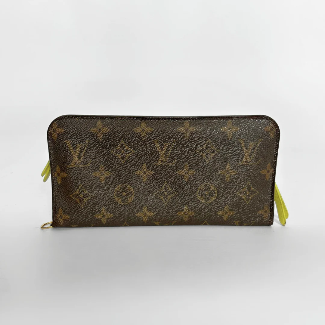 Louis Vuitton wallet with monogram pattern on a white background