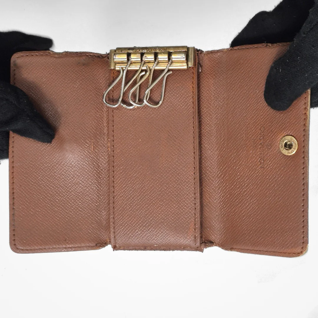 Louis Vuitton wallet with monogram pattern on white background
