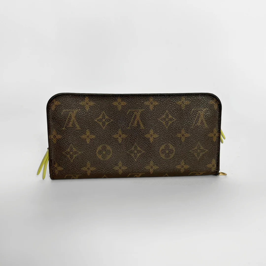 Brown wallet with monogram pattern on a white background