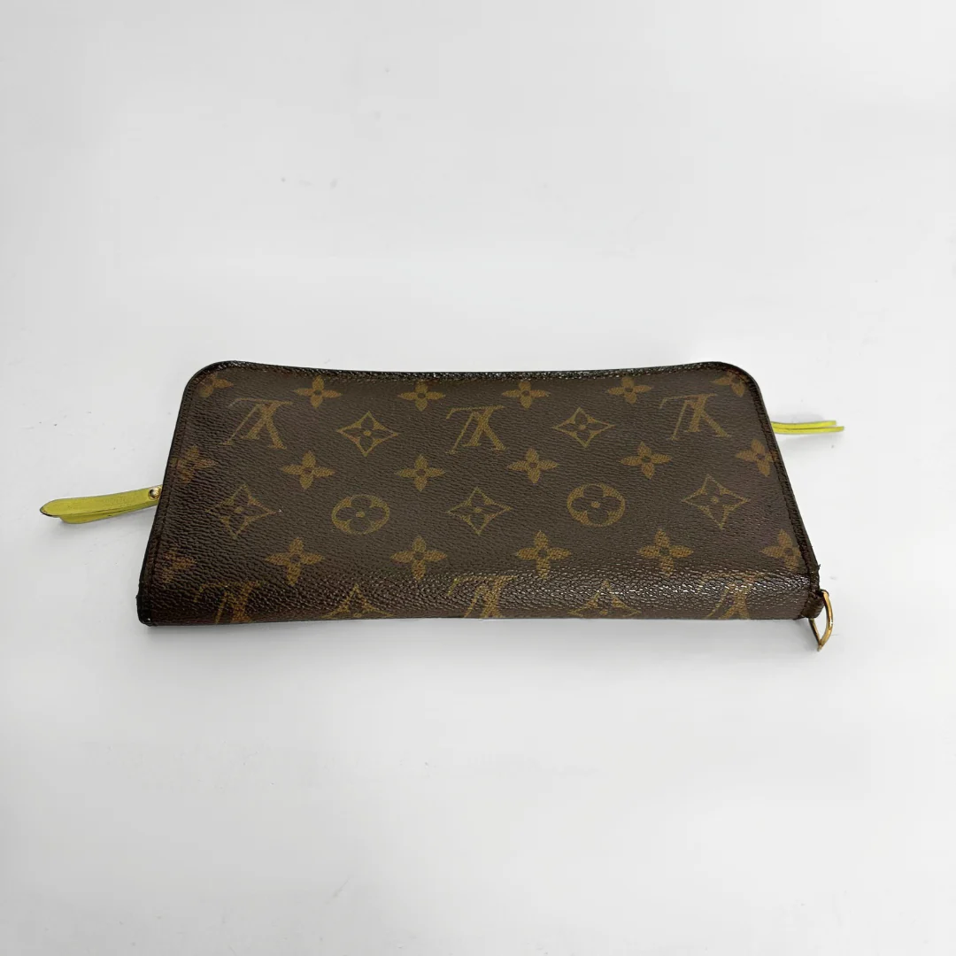 Designer wallet with monogram pattern on a white background
