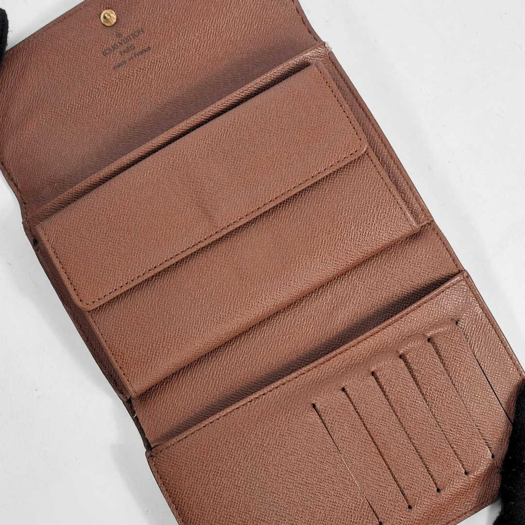 Brown leather wallet with multiple card slots on a white background