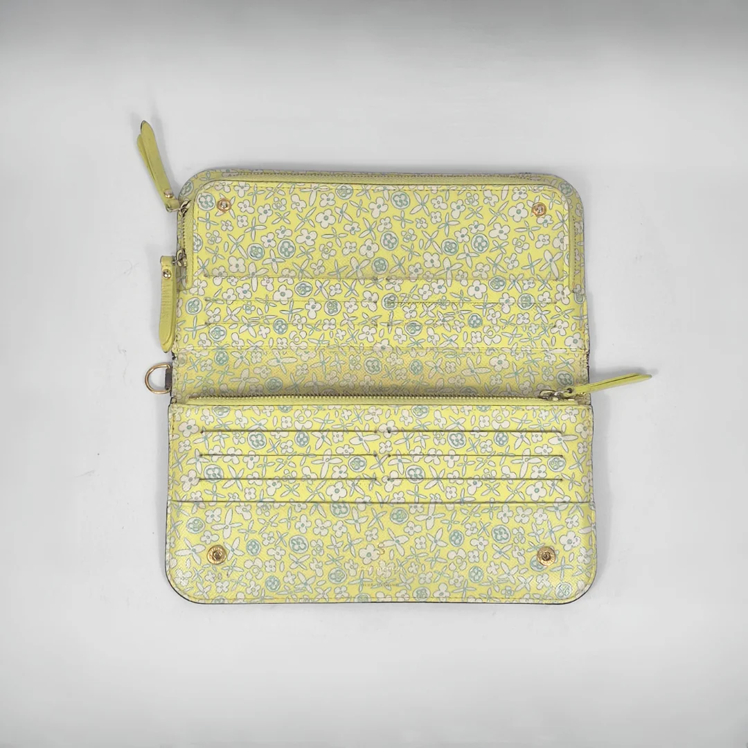 Floral patterned wallet with zippers on a light gray background