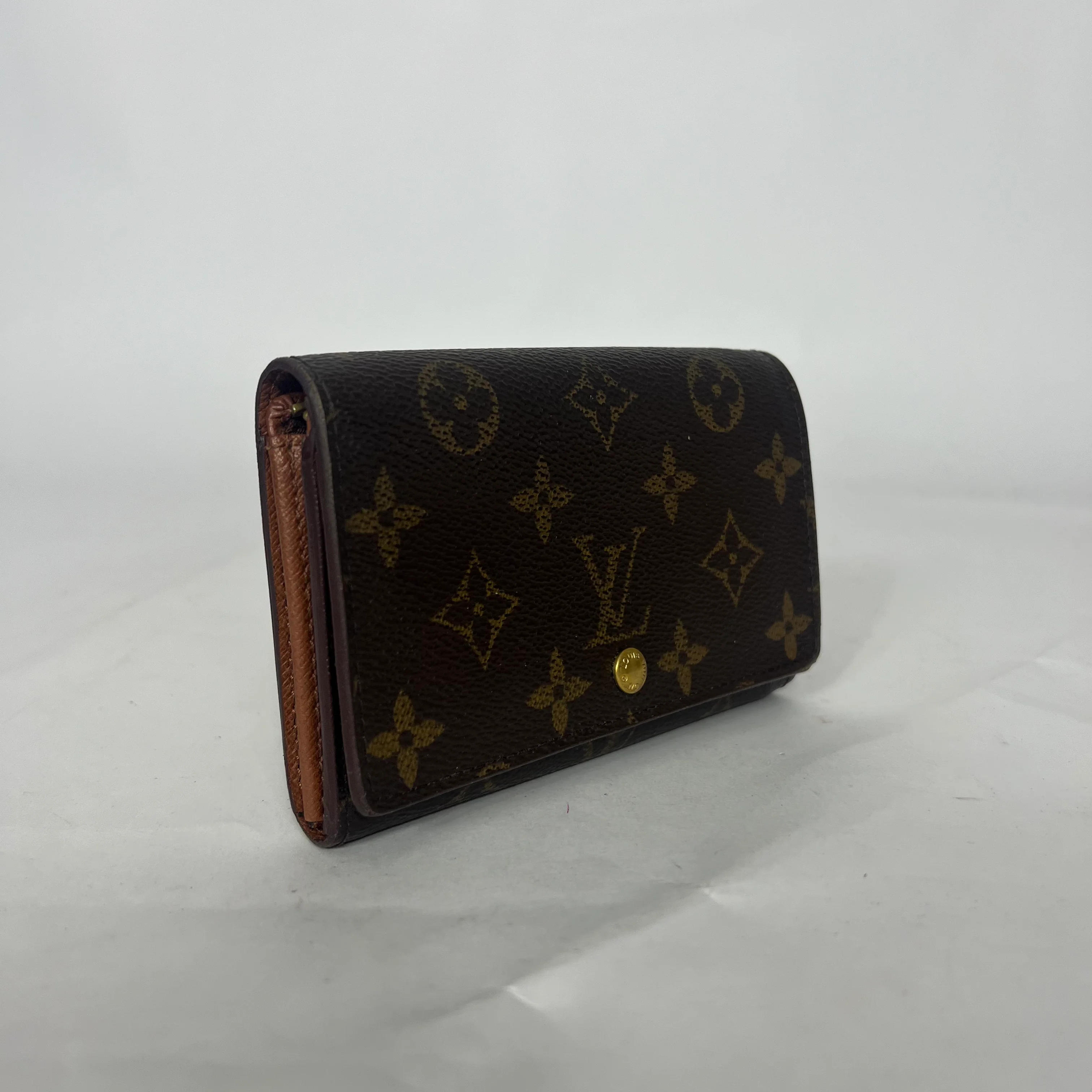 Designer wallet with monogram pattern on a white background