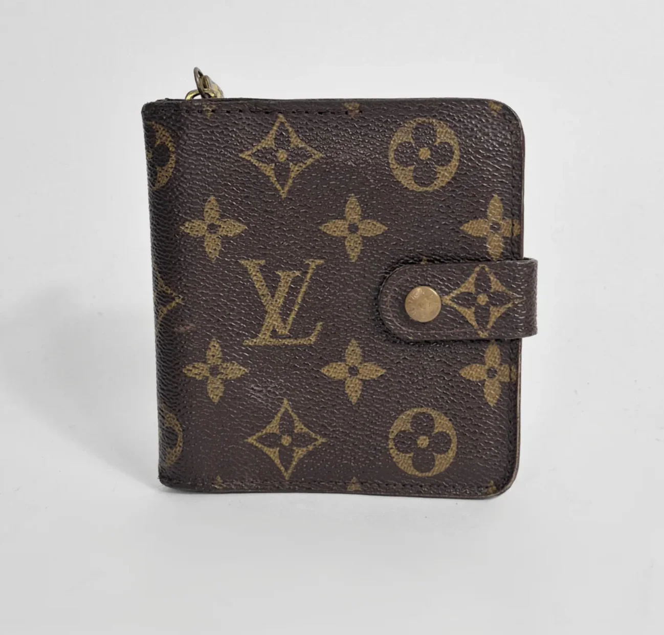 Louis Vuitton wallet with monogram pattern on a white background