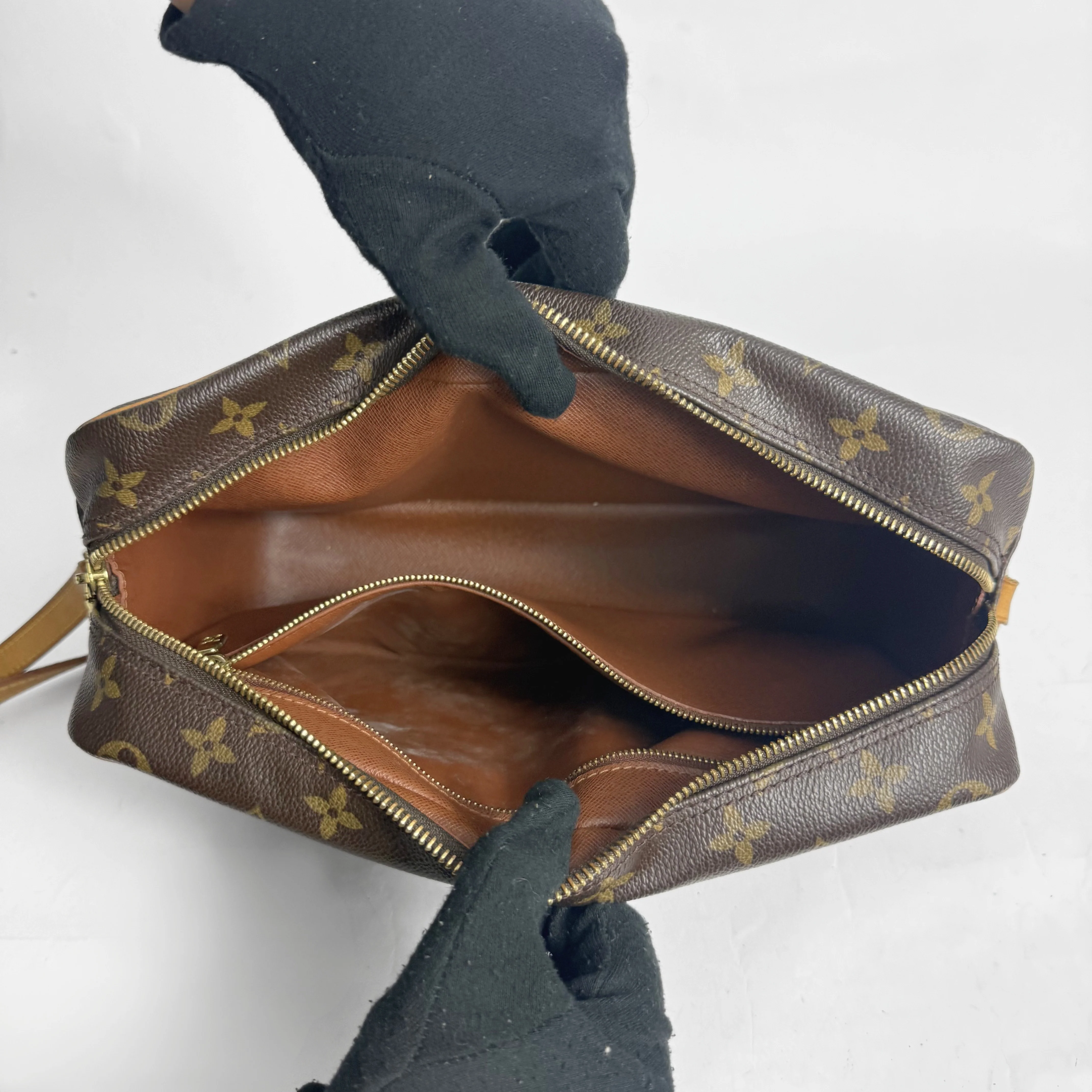 Brown handbag with gold monogram pattern